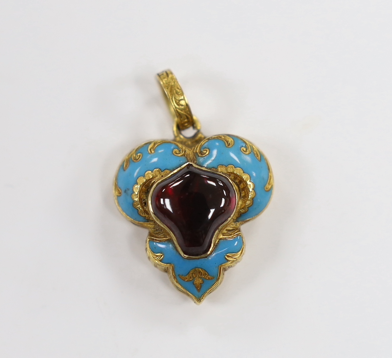 A Victorian yellow metal, blue enamel and garnet shaped triform pendant, overall 29mm, gross weight 4 grams.